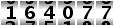 164077